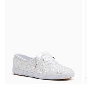 White glitter sneakers with white ribbon laces.
